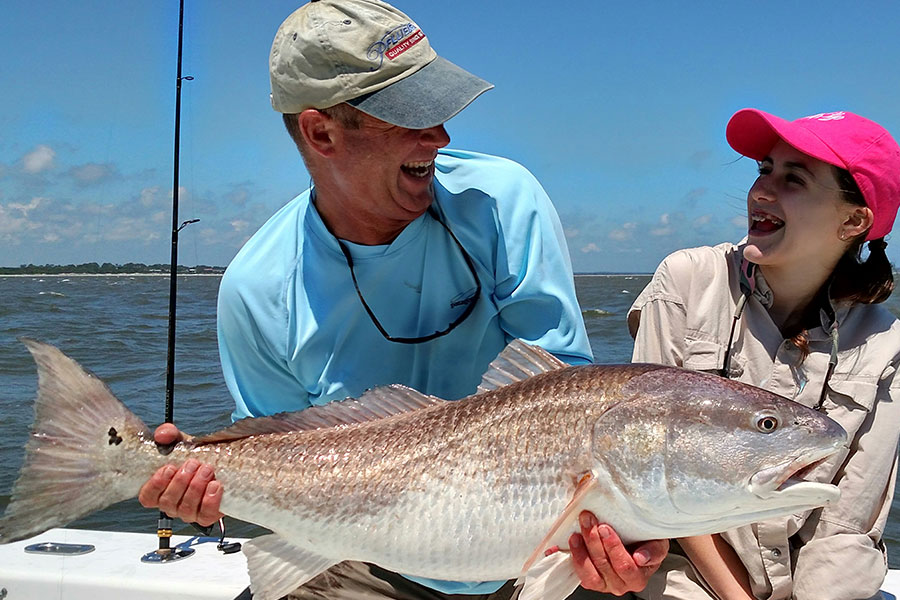 Capt. Greg Hildreth and a young angler with a redfish