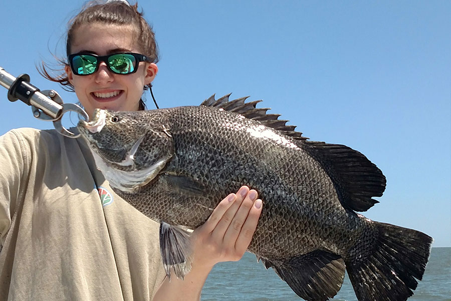 Young angler holding a tripletail caught near St. Simons Island