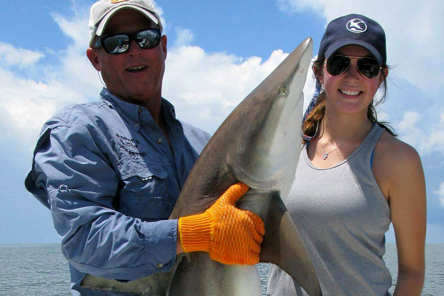 Capt. Greg and an angler holding a shark