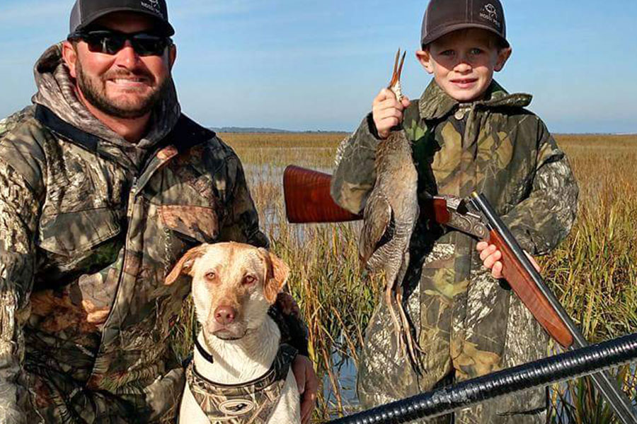 Father, son and retriever after a Georgia marsh hen hunt