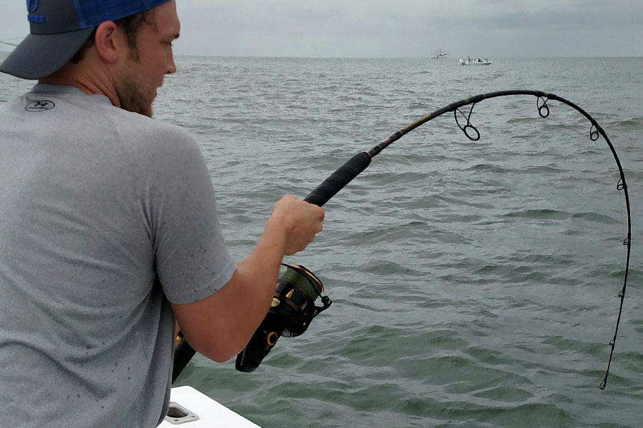 Angler with a bent rod fighting a fish in Coastal Georgia