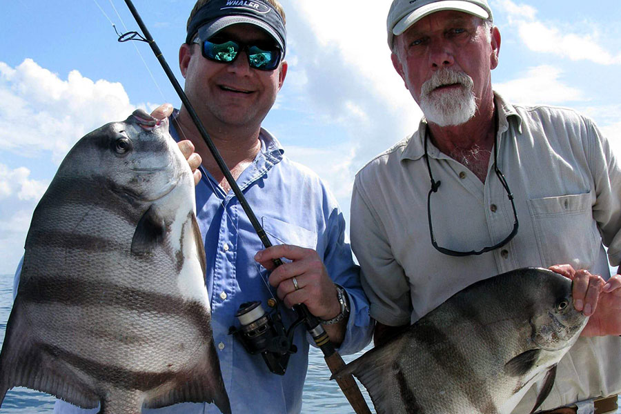 Two anglers holding big sheepshead near St. Simons Island