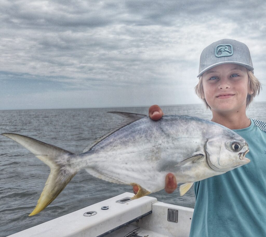 Young angler holding a jack crevalle