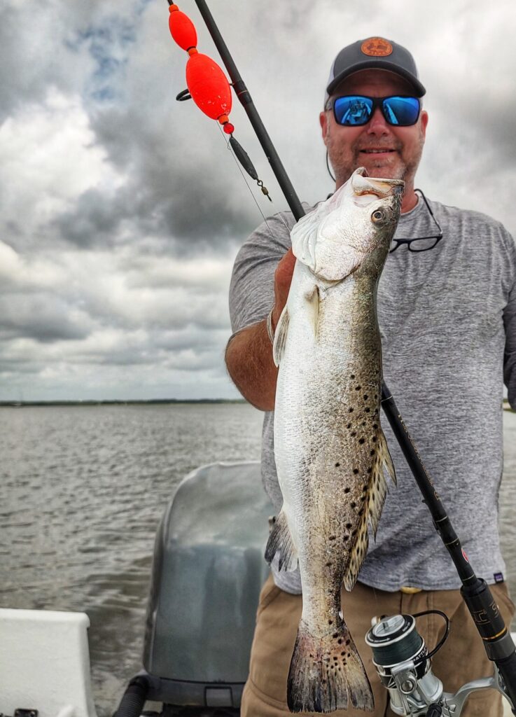 Angler holding a spotted seatrout